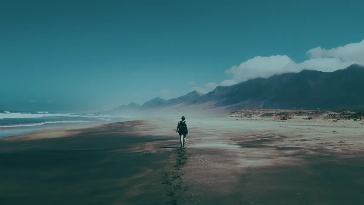 man walking alone on island beach